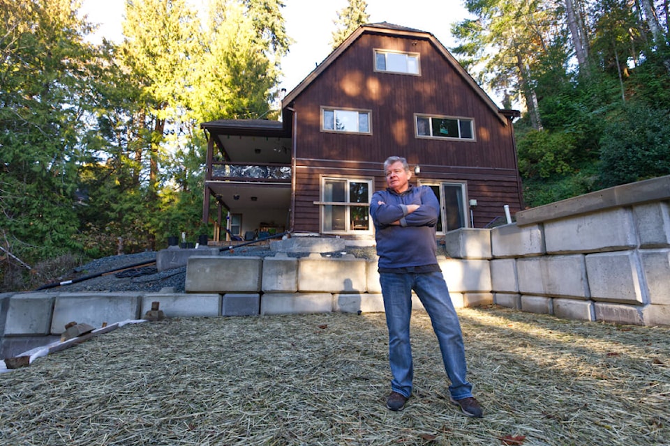 Jeff Morrow stands in his newly repaired backyard Tuesday (Nov. 15), one year to the day after a record-breaking rainstorm caused much of it to be washed into Millstream Creek. (Justin Samanski-Langille/News Staff)