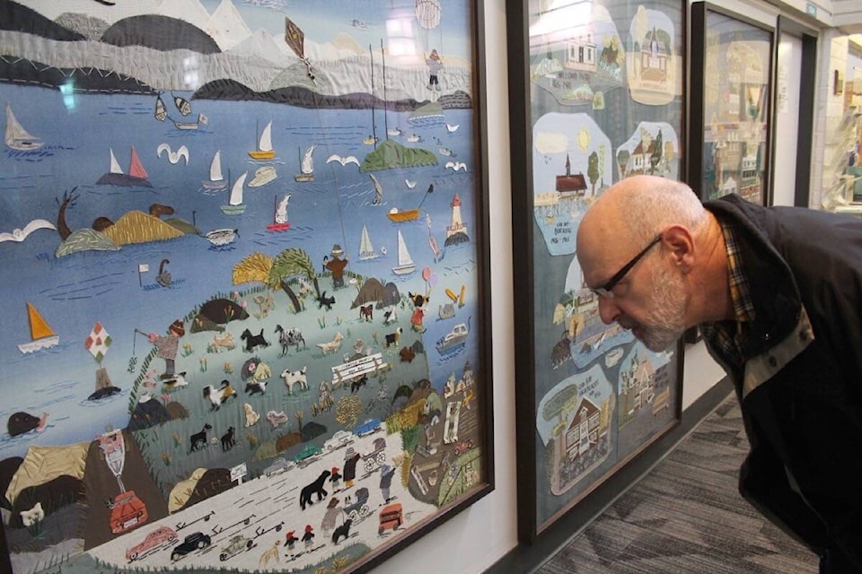 Kevin Grant inspects the details in his late mother’s work, restored and hung in pride of place in the Monterey centre lobby. (Christine van Reeuwyk/News Staff)