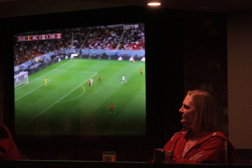 A woman watches on at a viewing party held at Wicket Hall for the men’s World Cup match between Canada and Belgium on Nov. 23. (Bailey Moreton/News Staff)