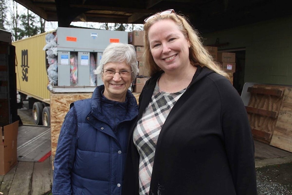 Dell Marie Wergeland, president of the CRW Society and Dr. Bridget Stirling, president of ICROSS Canada during the Jan. 25 packing of the latest container headed from Greater Victoria to help those living in Ukraine. (Christine van Reeuwyk/News Staff)