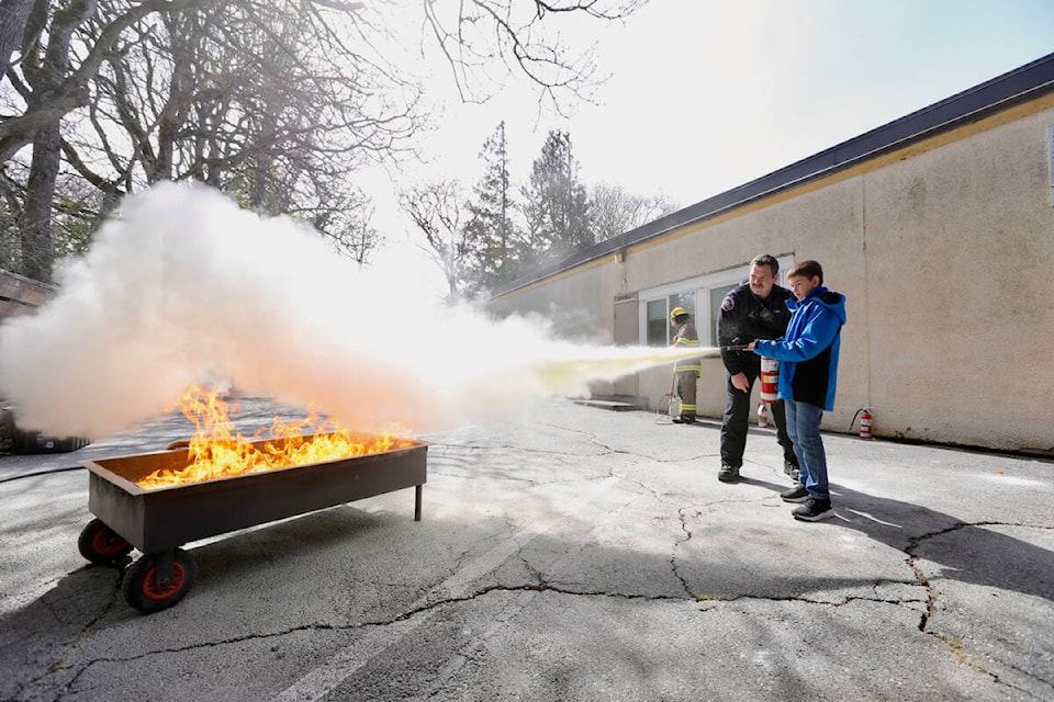 Damian Milic, a Grade 4 student at Sangster Elementary School, practices using a fire extinguisher Tuesday, April 25, during the annual Fire Safety Expo in Metchosin. (Justin Samanski-Langille/News Staff)