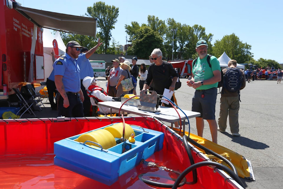 Visitors to the annual Coast Guard Days open house in Victoria check out a display showing some of the Canadian Coast Guard’s spill response equipment Saturday, June 3. (Justin Samanski-Langille/News Staff)