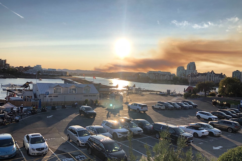 A fire burning north of Sooke sends smoke into the sky visible from the Inner Harbour in Victoria. 