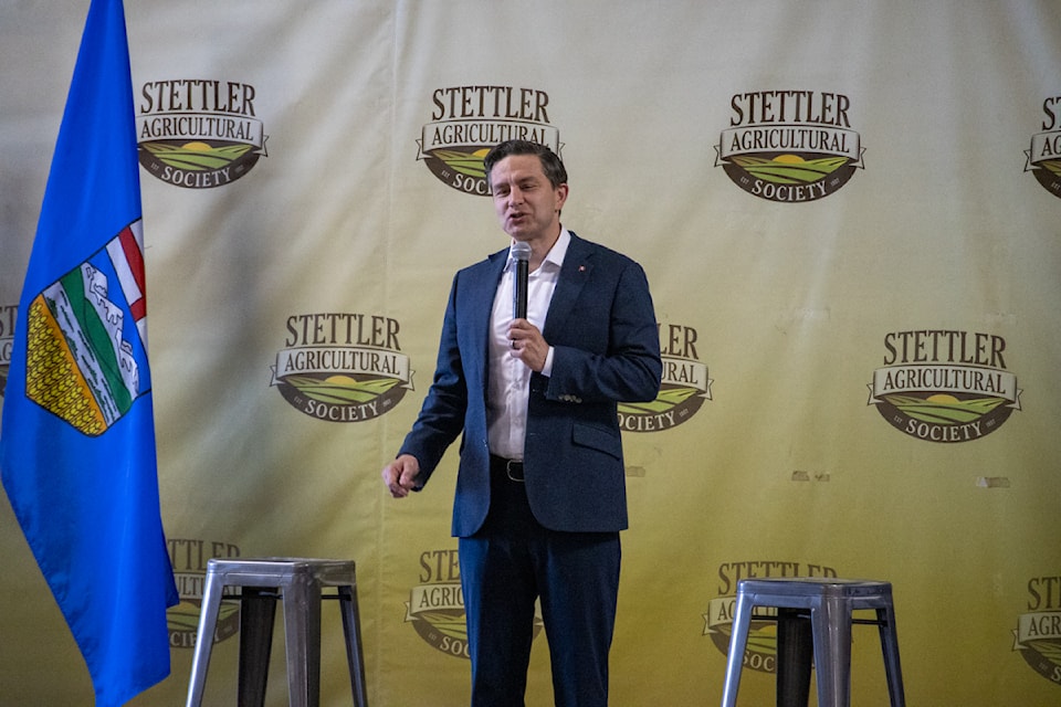 Pierre Poilievre gives a campaign-style speech during his Stettler appearance on July 11.
