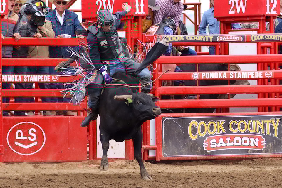 Tyler Craig hangs on during Professional Bull Riding at Ponoka Stampede on June 30.