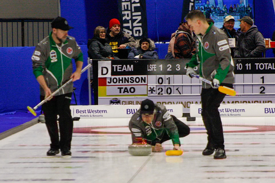 Team Johnson throws a rock during the second draw of the Boston Pizza Cup.