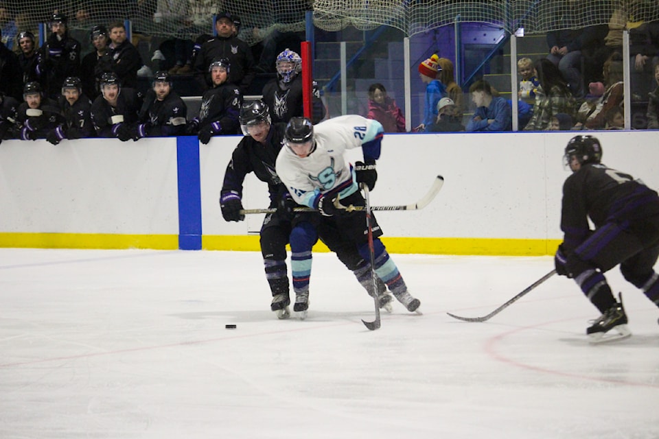 Sedgewick Sabre Landon Kelndorfer and a Stettler Imperial battle for the puck.