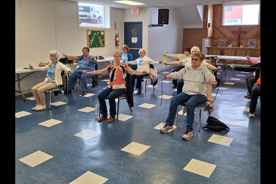 Seniors take part in chair yoga at the BESTOGETHER Seniors Conference on April 23.