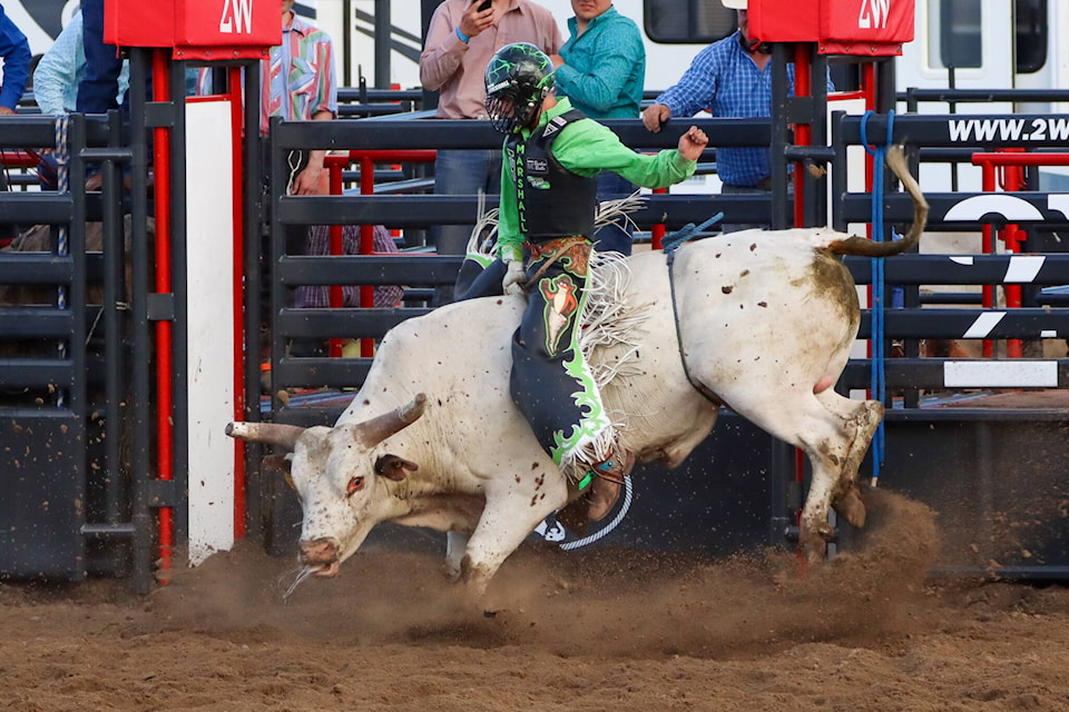Orrin Marshall of Conrach, Sask, rides for 79 points to win the Steel Wheel Stampede bull riding event June 10. (Kevin Sabo/Stettler Independent)