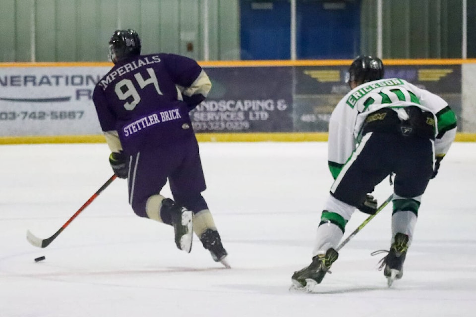 Imperial defenceman DJ Kistner grabs the puck and carries it out of the zone with Irma Aces Kylar Erickson hot on his heels. (Kevin Sabo/Stettler Independent)