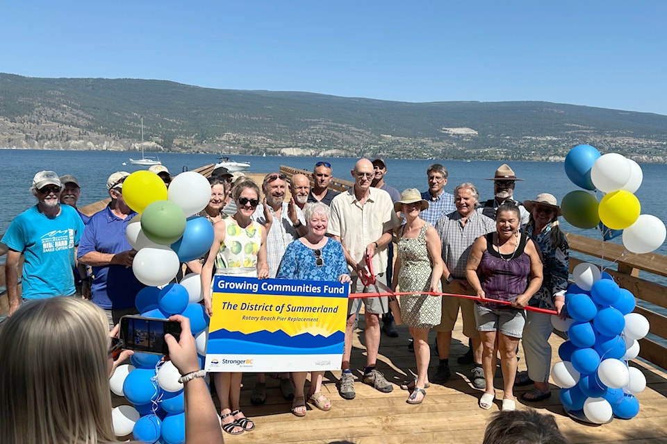 Members of Summerland’s council, the Rotary Club of Summerland, the Penticton Indian Band, municipal staff, contractors and the RCMP were present for the opening of the pier at Rotary Beach on July 11. (John Arendt/Summerland Review)