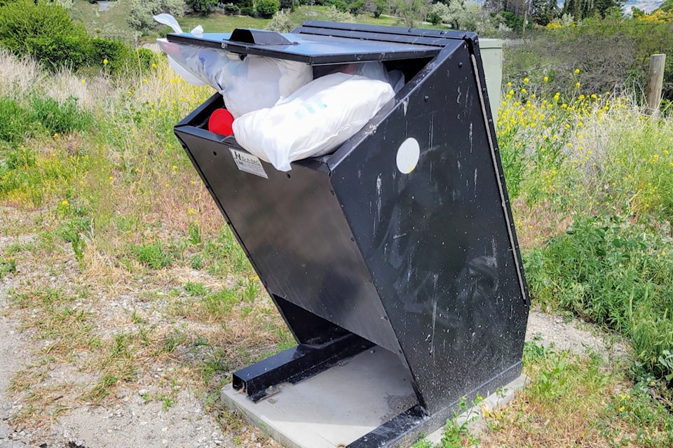 A garbage bin on a West Bench community pedestrian corridor is overflowing. The Regional District of Okanagan-Similkameen is noticing a growing problem with household garbage being dumped in bins in parks and along trails (Regional District of Okanagan-Similkameen)