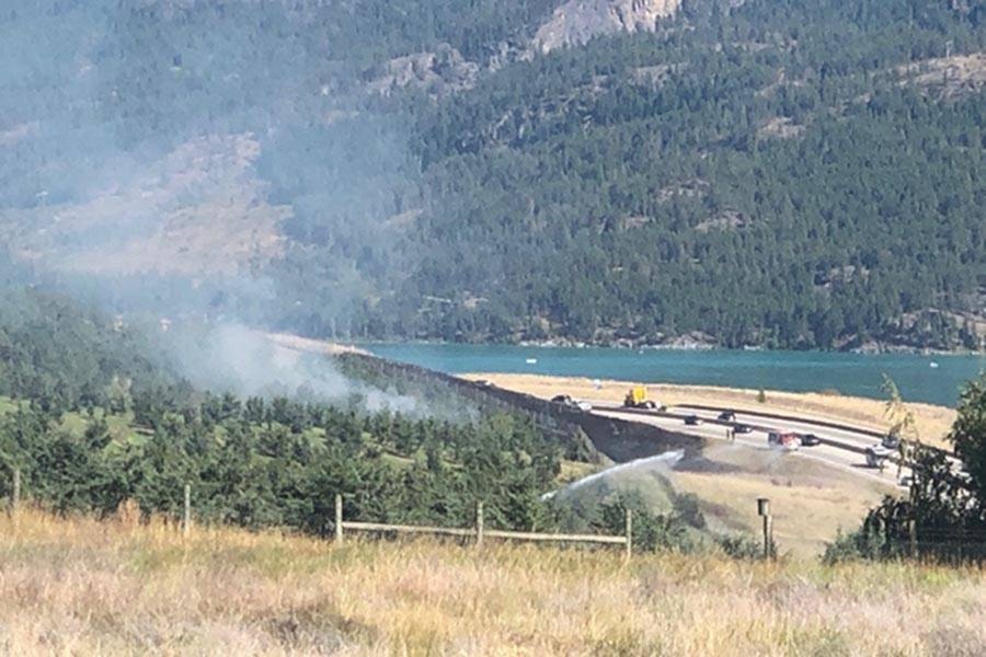 Grass fire Firefighters from B.C. Wildfire and Vernon Fire Rescue Services responded to a grass wildfire sparked along the side of Highway 97 south, near the Predator Ridge turnoff, on Thursday afternoon. (Jennifer Smith - Morning Star)
