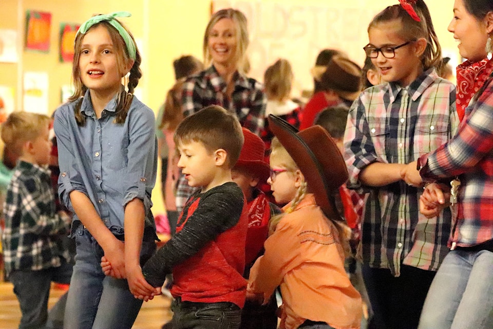 Big and little buddies partner up for Coldstream Elementary’s Harvest Hoedown. Annika Malby (left) is dancing with little buddy Liam Leblanc, with Myrissa Henke ahead of Brynlee Dranchuk promenading with Kindergarten teacher Mrs. Rhodes. (Jennifer Smith - Morning Star)