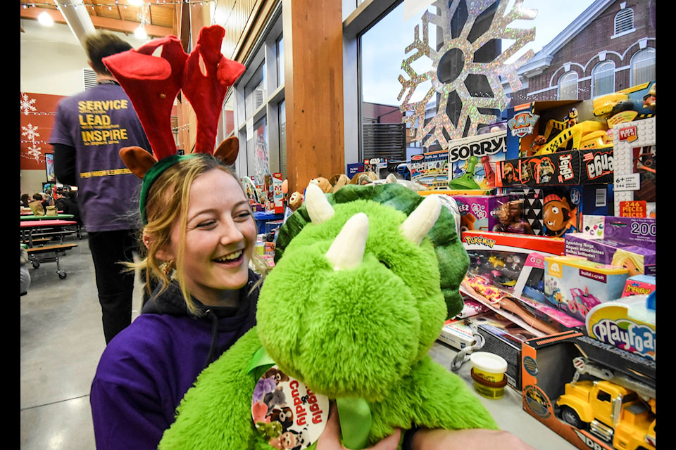 Claire Taylor of the Pen High leadership program snuggles up with one of the donated gifts. (Mark Brett - Western News)