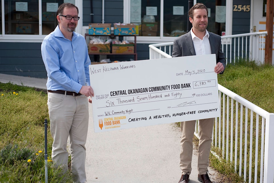 Chris Laurie (right), president of the West Kelowna Warriors, presents a $6,780 cheque to Trevor Moss (left), CEO of the Central Okanagan Food Bank, on May 5, 2020. (Michael Rodriguez - Capital News)