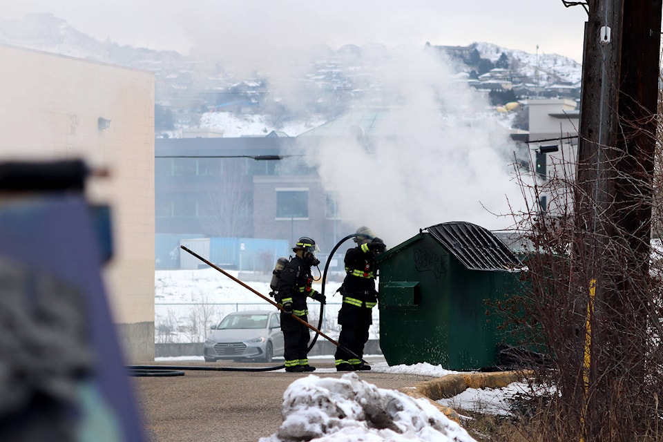 Vernon firefighters douse a fire inside a cardboard bin behind the Shops at Polson off Highway 6 Wednesday, Jan. 20. (Jennifer Smith - Morning Star)