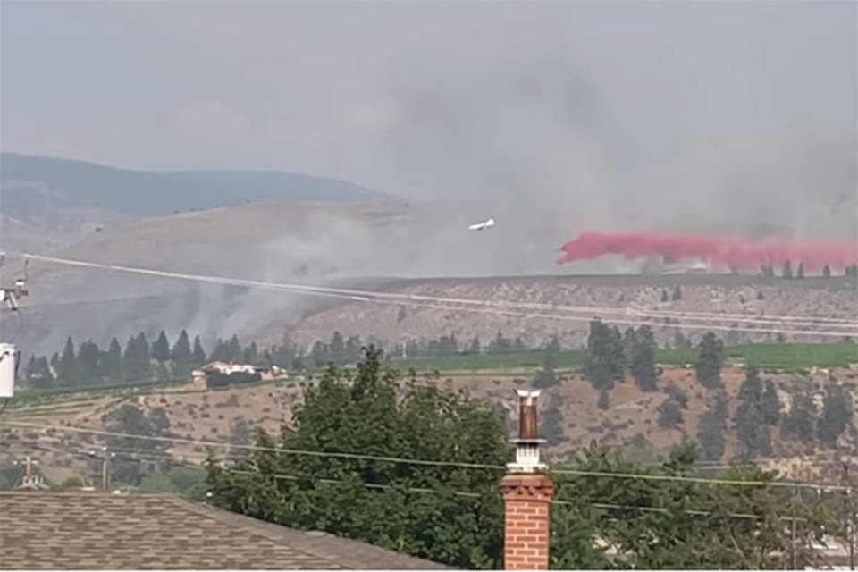 Air bombers drop fire retardant on the new wildfire that erupted near the town of Oliver Sunday evening. The out of control blaze started around 4:40 p.m. (Facebook)