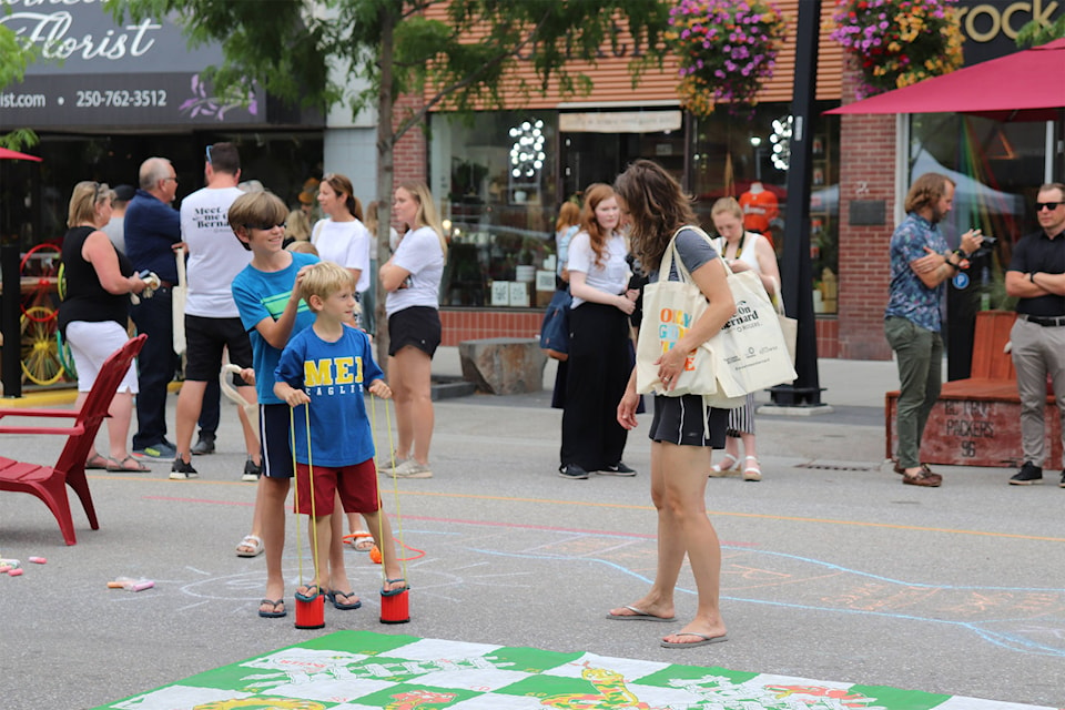 A family checks out the activities on the Bernard Avenue closure on Wednesday, July 7. (Isabella Harmel/Capital News)