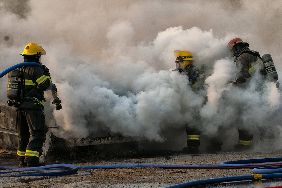 Osoyoos firefighters work quickly to put out a car fire Saturday, July 18. (Roger Richardson photo)