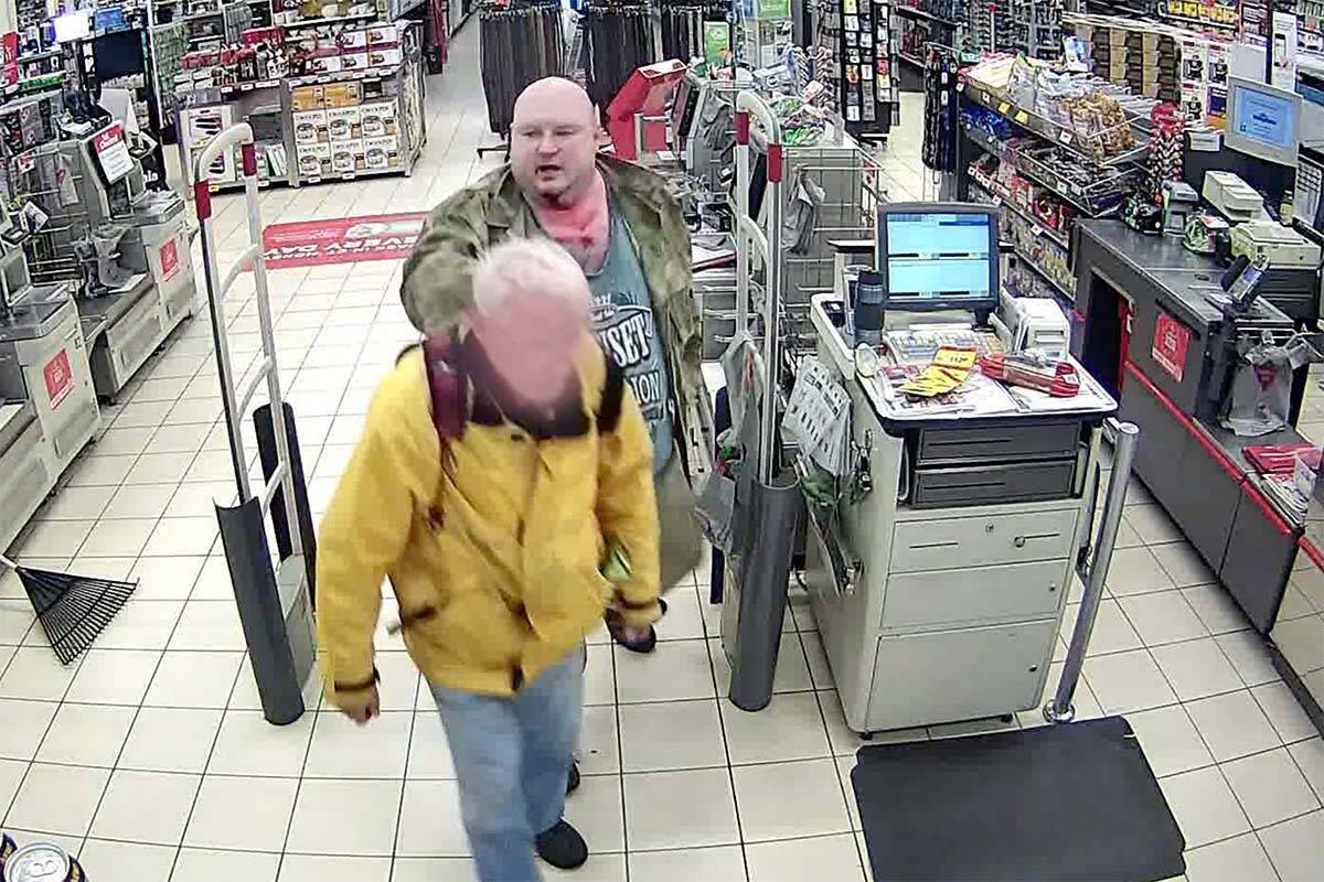 Daniel Rintoul (behind) walks hostage Harry Burderer out of a Vancouver Canadian Tire on Nov. 10, 2016. (Screenshot/Video footage courtesy of the BC Coroners Court)