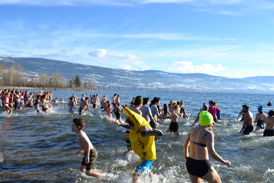 Some dressed in costume, like Chase Tamminga in a banana suit, took the plunge into the New Year at Sun-Oka beach in Summerland Jan. 1. (Monique Tamminga Western News)