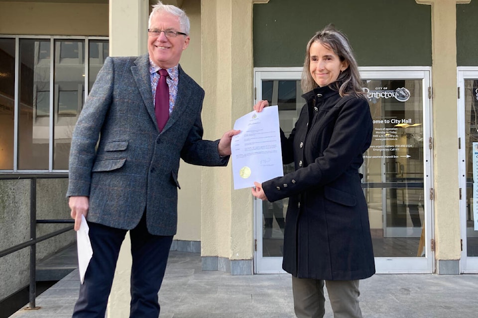 Penticton mayor Julius Bloomfield presents the Community Radio Week Proclamation to Claire Thompson, the CFUZ president, on the steps of city hall. For the first time in Penticton’s history, the first week of February has been designated as Community Radio Week. (Photo- Peach City Community Radio Society)