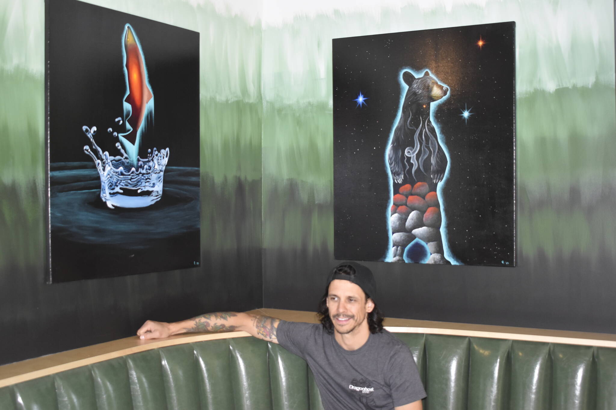 General manager Keith Corbett engaged with local artists to help craft piece for pubs interior. Corbett is seen here sitting by the paintings of Indigenous Syilx artist Cody Lecoy. Jennifer Long, Clinton George, Gord Wylie and the Penticton Museum and Archives also contributed to the art that can be seen inside. (Logan Lockhart/Western News)