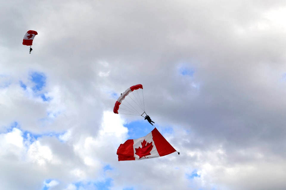 With O’ Canada playing down below, the SkyHawks floated down with a giant Canadian flag to start their Peach Fest show above Okanagan Lake Park on Wednesday evening. (Monique Tamminga Western News)