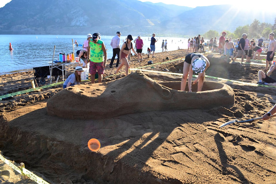 Reg and his family, grandkids from Calgary created a giant Croc sandal in the Peach Fest sandcastle competition. (Monique Tamminga Western News)