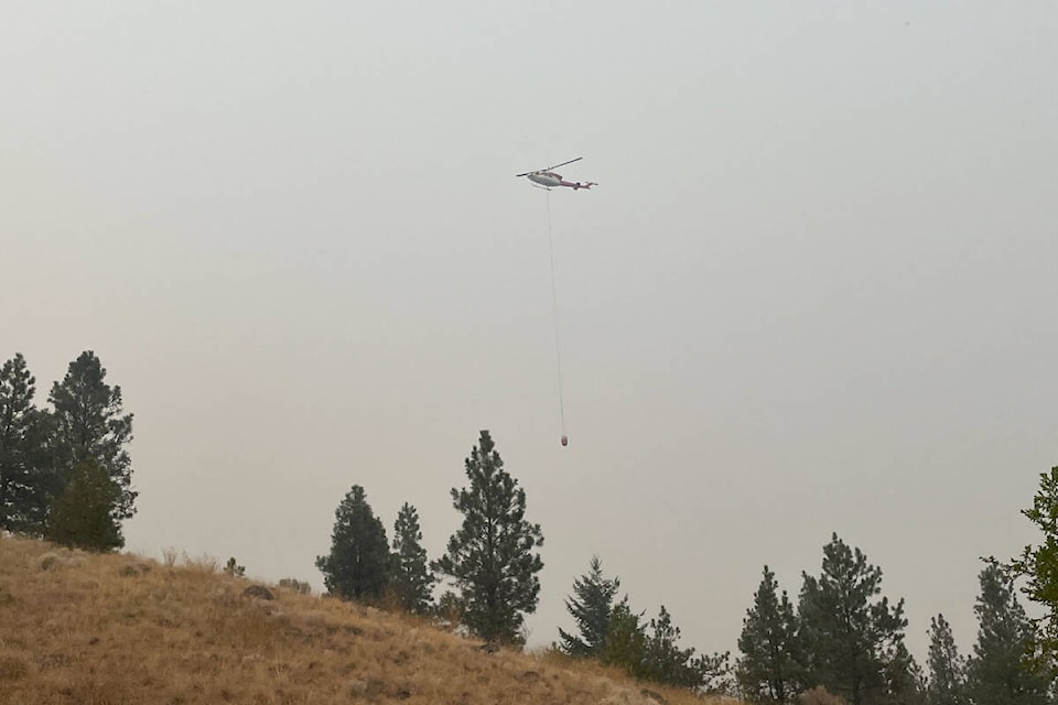 Crews are responding a fast-moving grass fire on Saturday, Aug. 19, in West Bench. (Brennan Phillips/Western News)