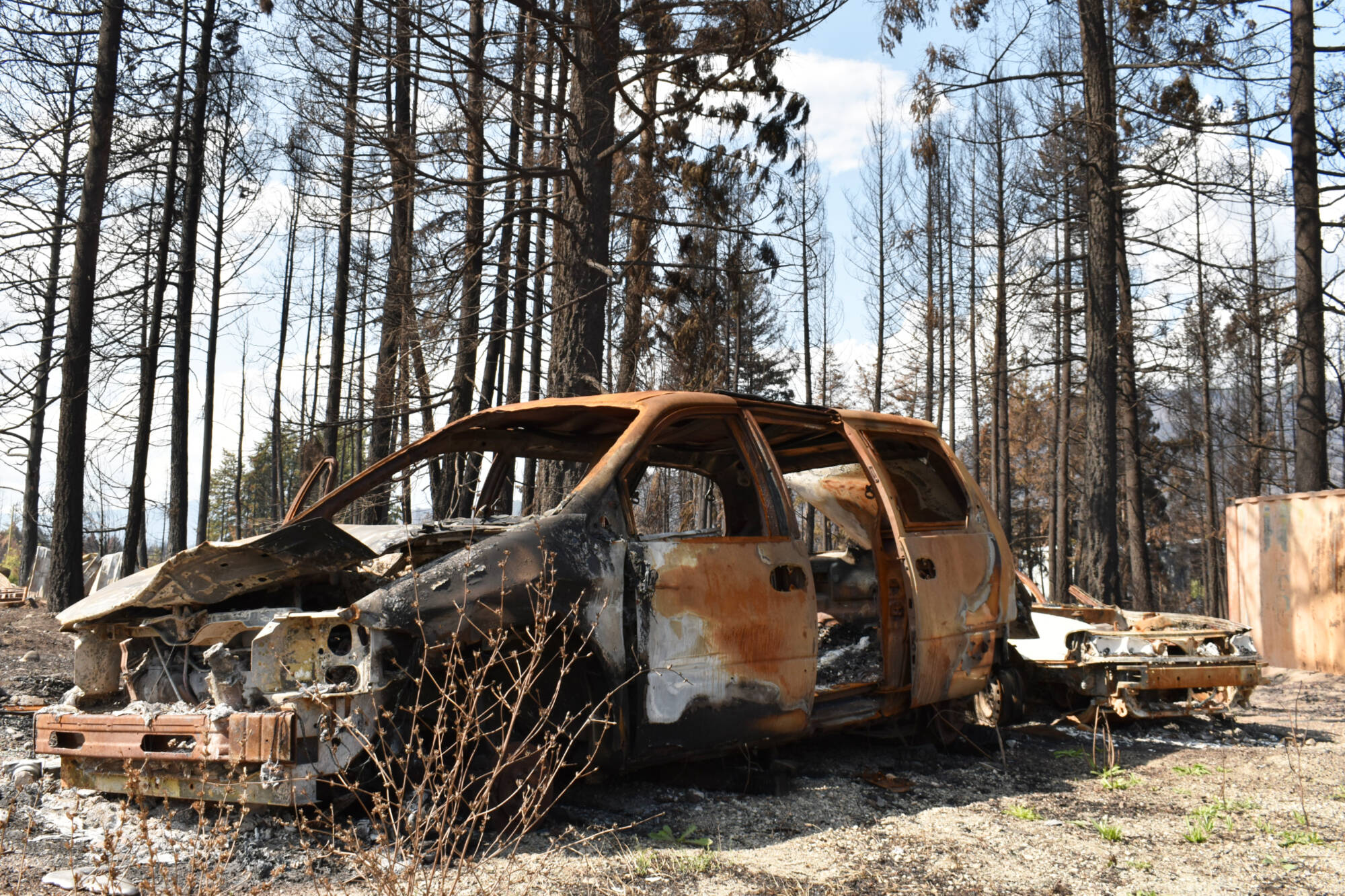 Burned cars sit at the back of the Scotch Creek/Lee Creek fire hall lot, where the Bush Creek East fire swept up and overwhelmed firefighters working out of the detachment. (Rebecca Willson-Salmon Arm Observer)