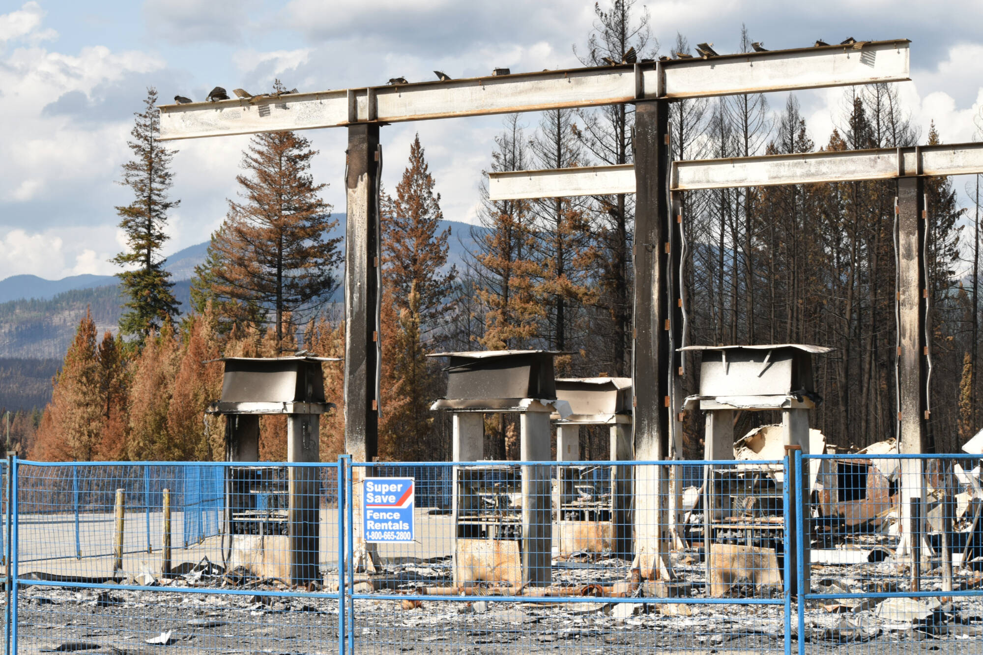 Charred gas pumps still stand at the burned Squilax Chevron gas station. (Rebecca Willson-Salmon Arm Observer)