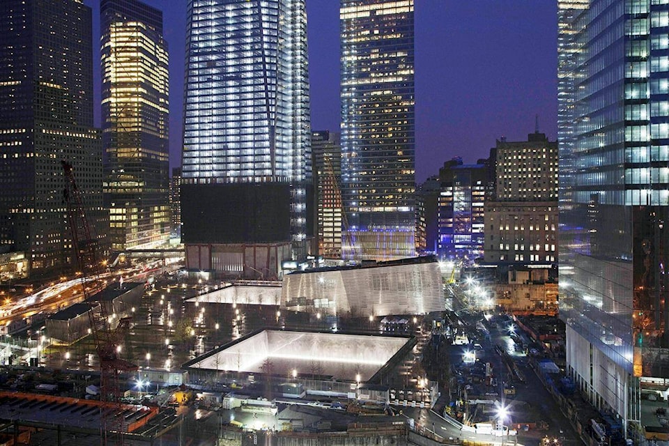 FILE — The twin reflecting pools, center, of the National September 11 Memorial are illuminated during the evening, April 1, 2012, at the World Trade Center, in New York. Americans are looking back on the horror and legacy of 9/11, gathering Monday, Sept. 11, 2023, at memorials, firehouses, city halls and elsewhere to observe the 22nd anniversary of the deadliest terror attack on U.S. soil. (AP Photo/Mark Lennihan, File)
