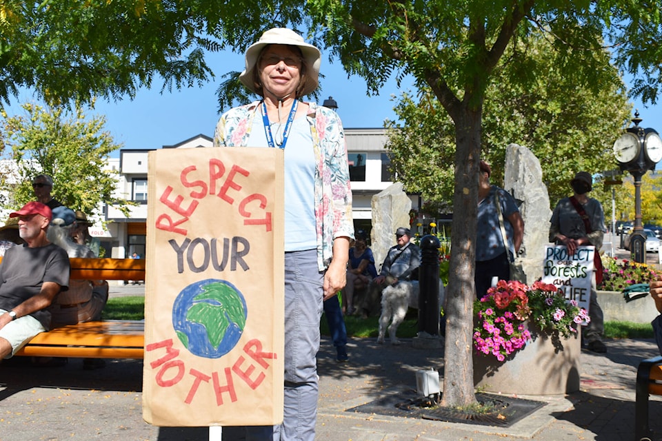 Regina Price stands with her sign addressing climate action at the strike held in Salmon Arm Friday, Sept. 15, 2023. (Rebecca Willson-Salmon Arm Observer)