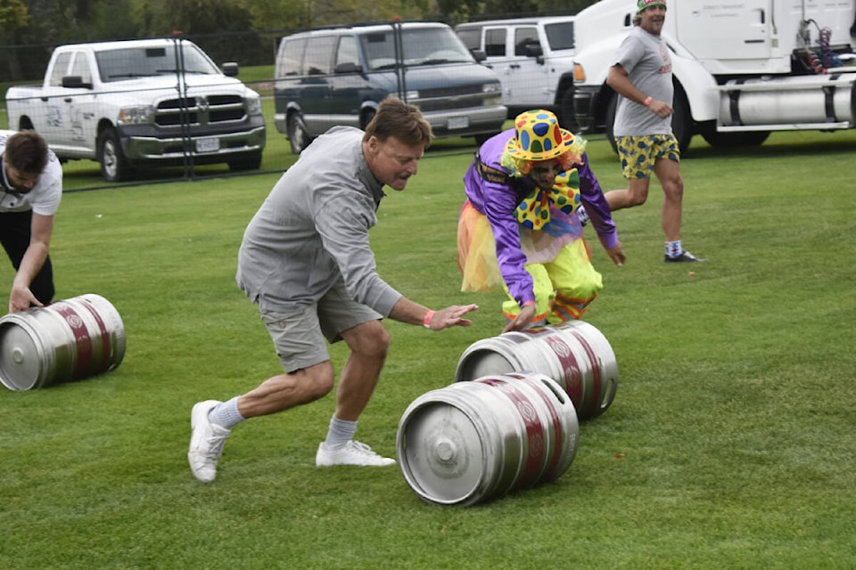 Teams compete in the barrel roll in Beery Olympics at Cask and Keg in Oliver on Saturday. (Logan Lockhart Western News)