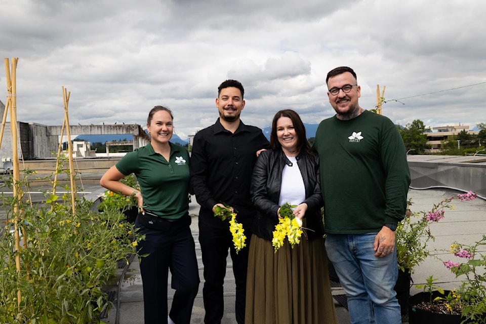Zoe Hughes, from MicroHabitat Urban Farms, left, Janna Vohora, general manager of Guildford Town Centre, Diego Oliveira, events and digital communications coordinator at Surrey Food Bank, and Nicholas Gilroy, MicroHabitat Urban Farms, pose for a photo in MicroHabitat's urban farm on top of Guildford Town Centre in Surrey on Wednesday, July 31, 2024.  


