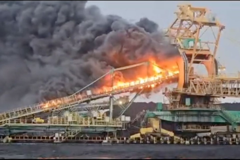 In photos posted to social media, the fire appeared to engulf parts of a coal stacker at the port.