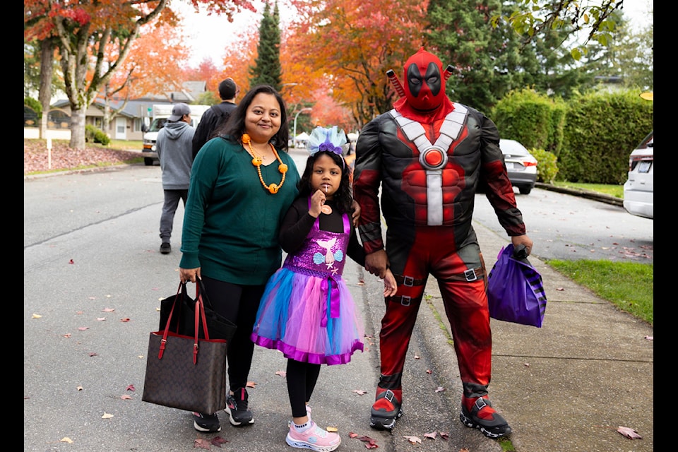Nivedita Day, Disha Day, 8, and Indranil Day pose for a photo at the Treat Accessibility Halloween village event for children with disabilities in Surrey on Saturday, Oct. 26, 2024. 