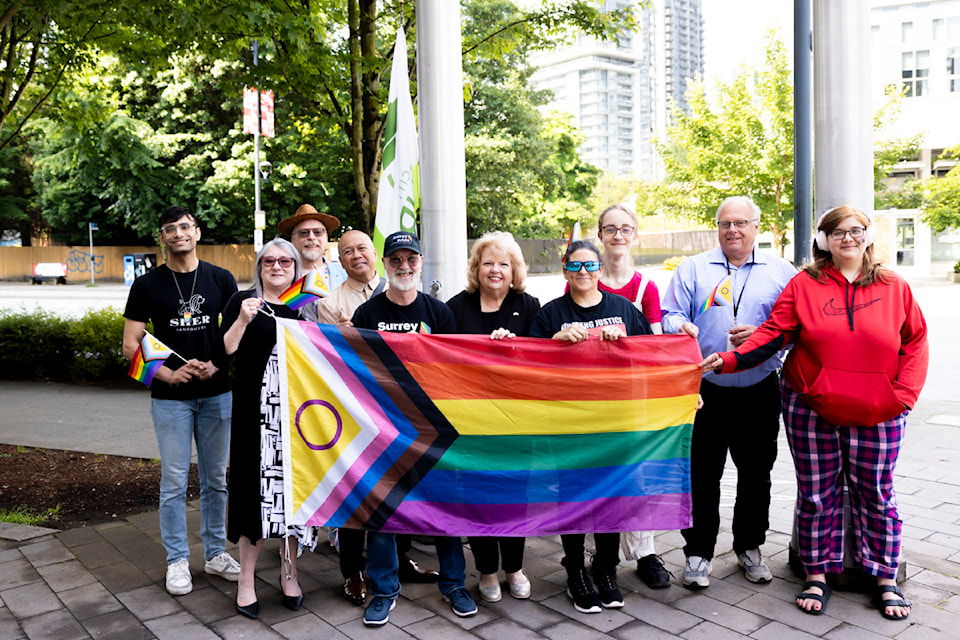 Karn Singh Sahota, left, Jen Marchbank PhD, two members of the community from Pinoy Pride Vancouver Society, Martin Rooney, Mayor Brenda Locke, Annie Ohana, Amy Sanderson, Councillor Mike Bose and Precious Bardonnex Herrera pose for a photo before the Pride flag was raised at Surrey's City Hall for the third year in a row on Tuesday, June 24. 