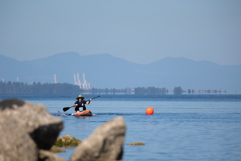 Jordan Niles from Surrey Fire SUPerstars team paddling in group a, race 1 at Surrey Hospitals Foundation 6th annual Champion of Crescent at Blackie Spit Park in Surrey on Saturday, July 13, 2024.  