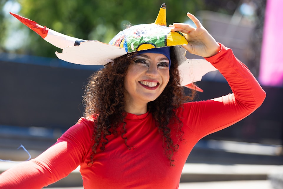 Cultural pavilion organizers walking in the Parade of Culture at the Surrey Fusion Festival in Holland Park in 2024. 