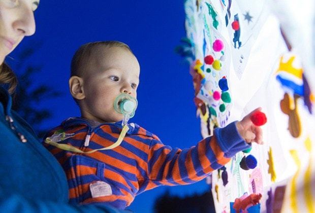 Jonny William of North Delta looks intently at the Community Luminary Wall.