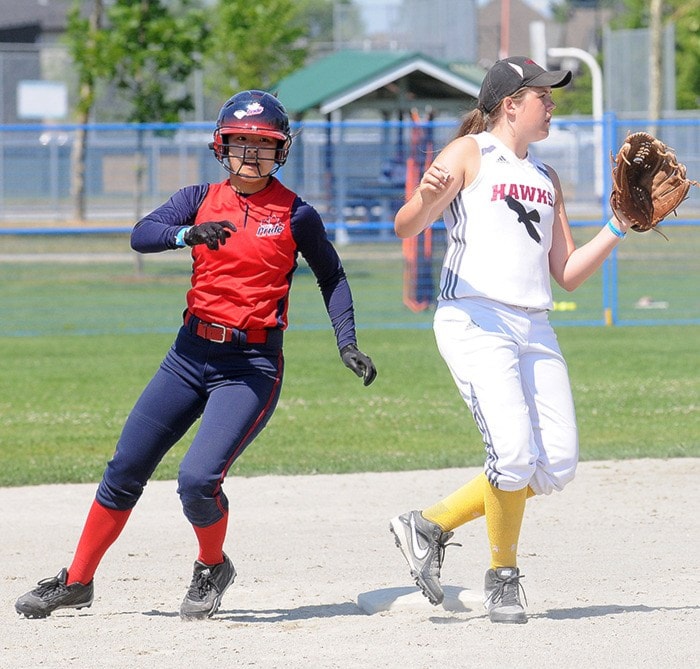 Ashley Yu rounds second base against Hannah Battersby of the Hawks