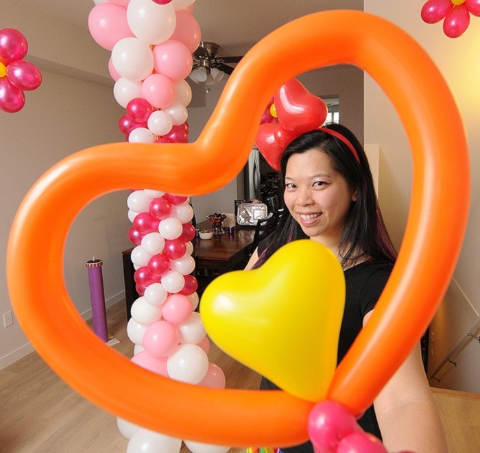 Balloon artist Kristal Yee with some of her creations. EVAN SEAL / THE LEADER