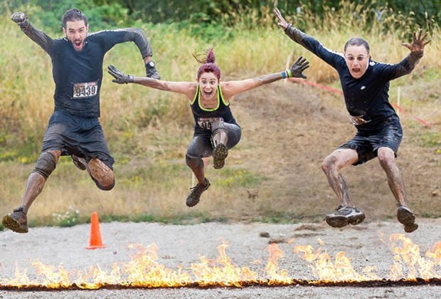 Jordan, Victoria, and Juan leaping a line of fire.