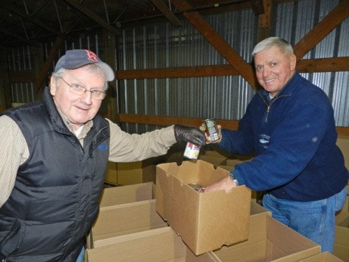 Volunteers Jack Bell and Larry Whitty pack Christmas hampers for Deltassist