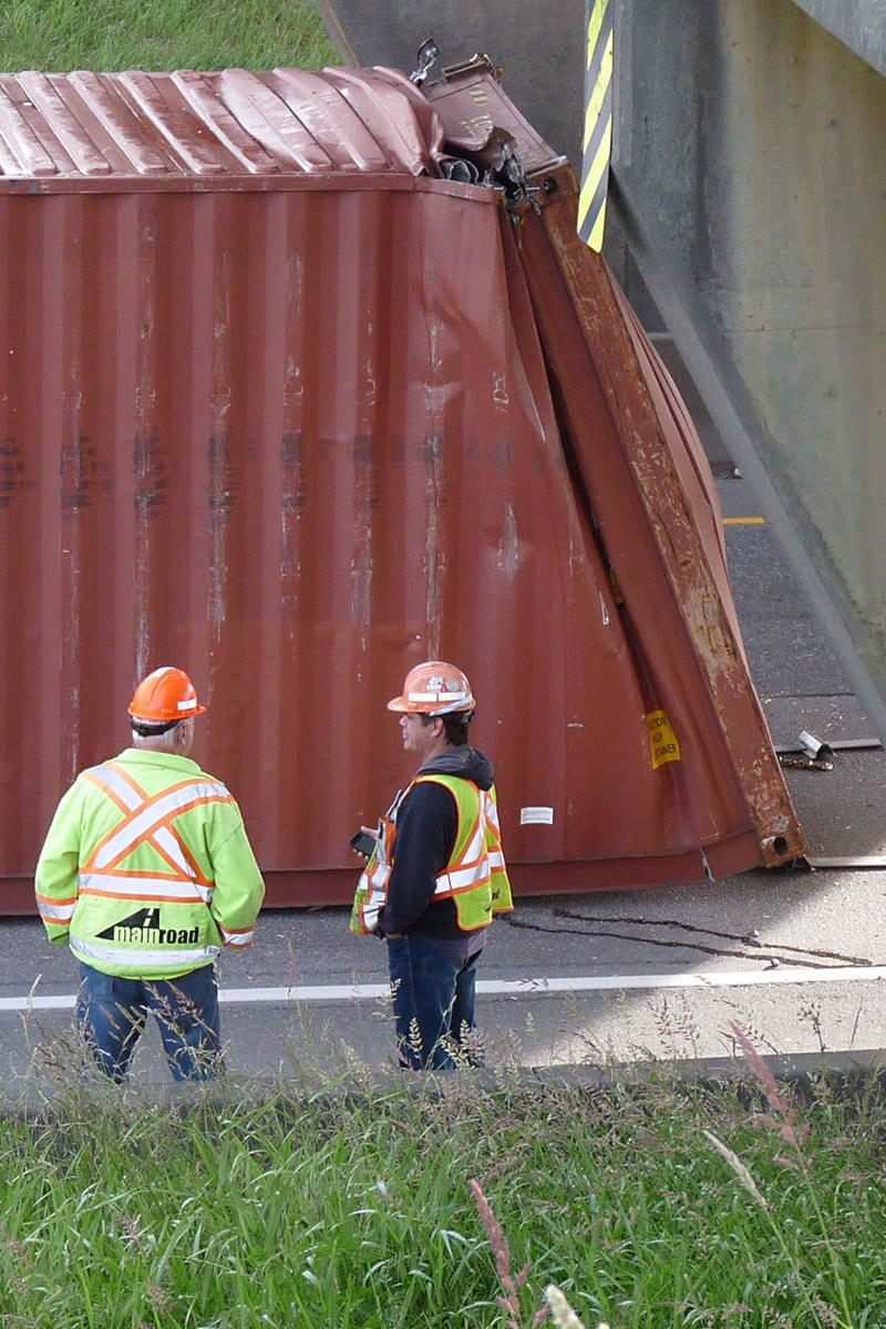 12280750_web1_180612-LAT-crumpled-container-blocks-highway-vertical