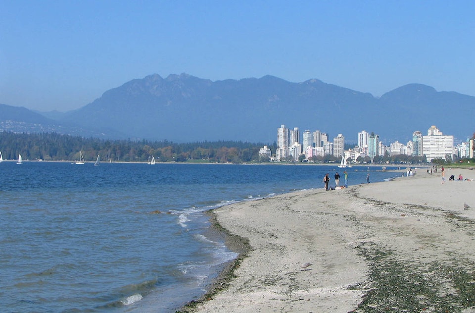 12969469_web1_Kitsilano_Beach_with_the_West_End_Stanley_Park_and_the_North_Shore_Mountains_in_the_distance