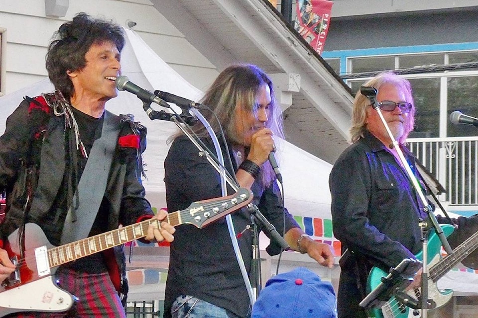 Prism’s Al Harlow, left, who was suffering from laryngitis, brought in a little help with vocals from singer Shawn Klatt on Thursday night as the Canadian rock band kicked of the summer’s Concerts for the Pier series. (Sheila LaRose photo)